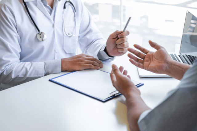 Doctor and patient discussing symptoms during a consultation.