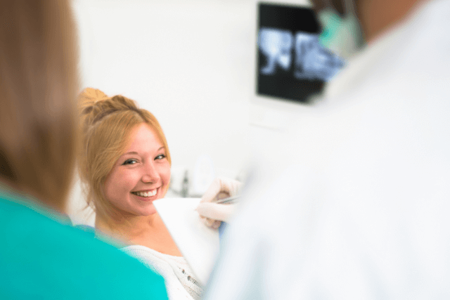 A woman radiating happiness and fulfillment after undergoing a minimally invasive procedure.